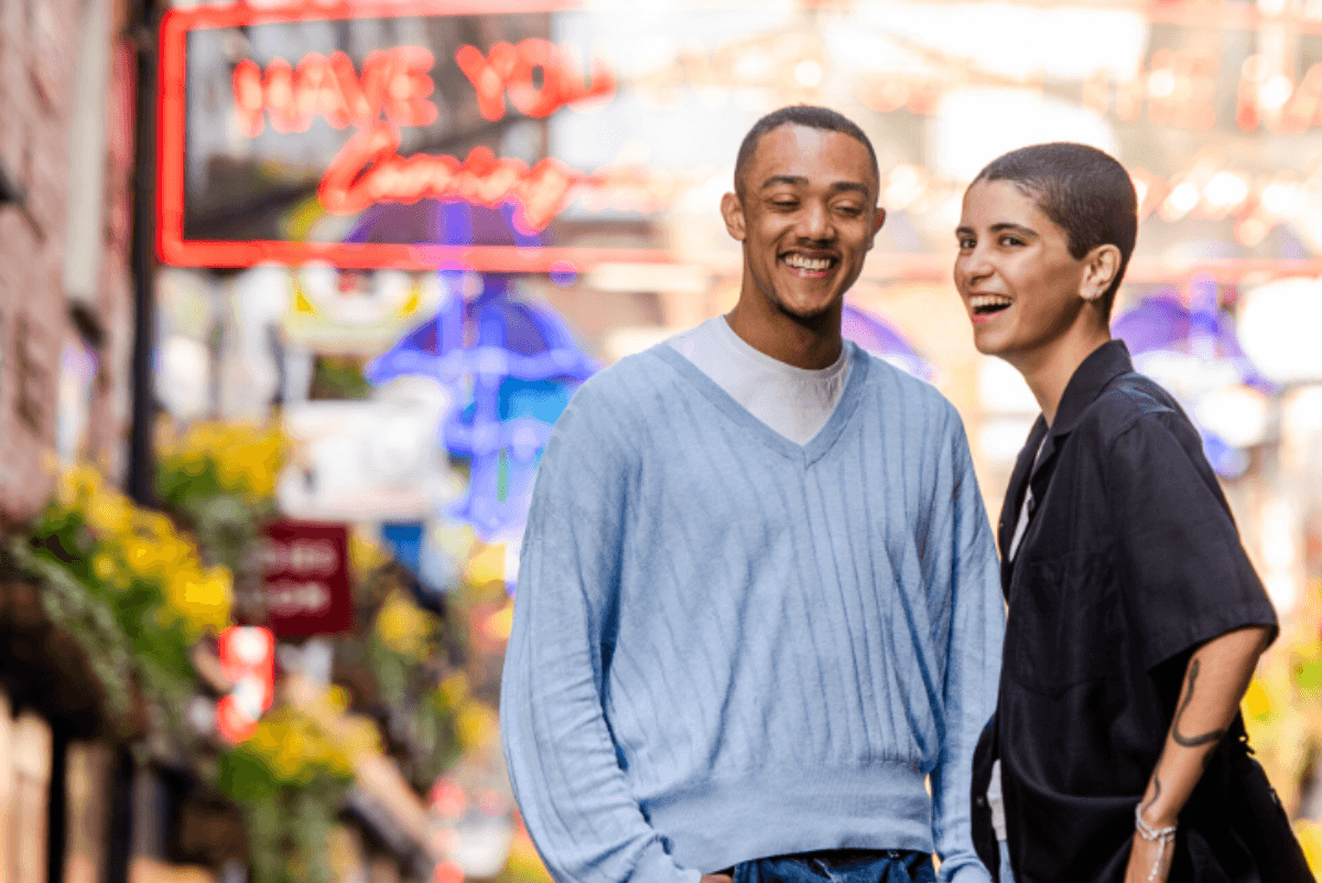 two people standing outside on a street&nbsp;