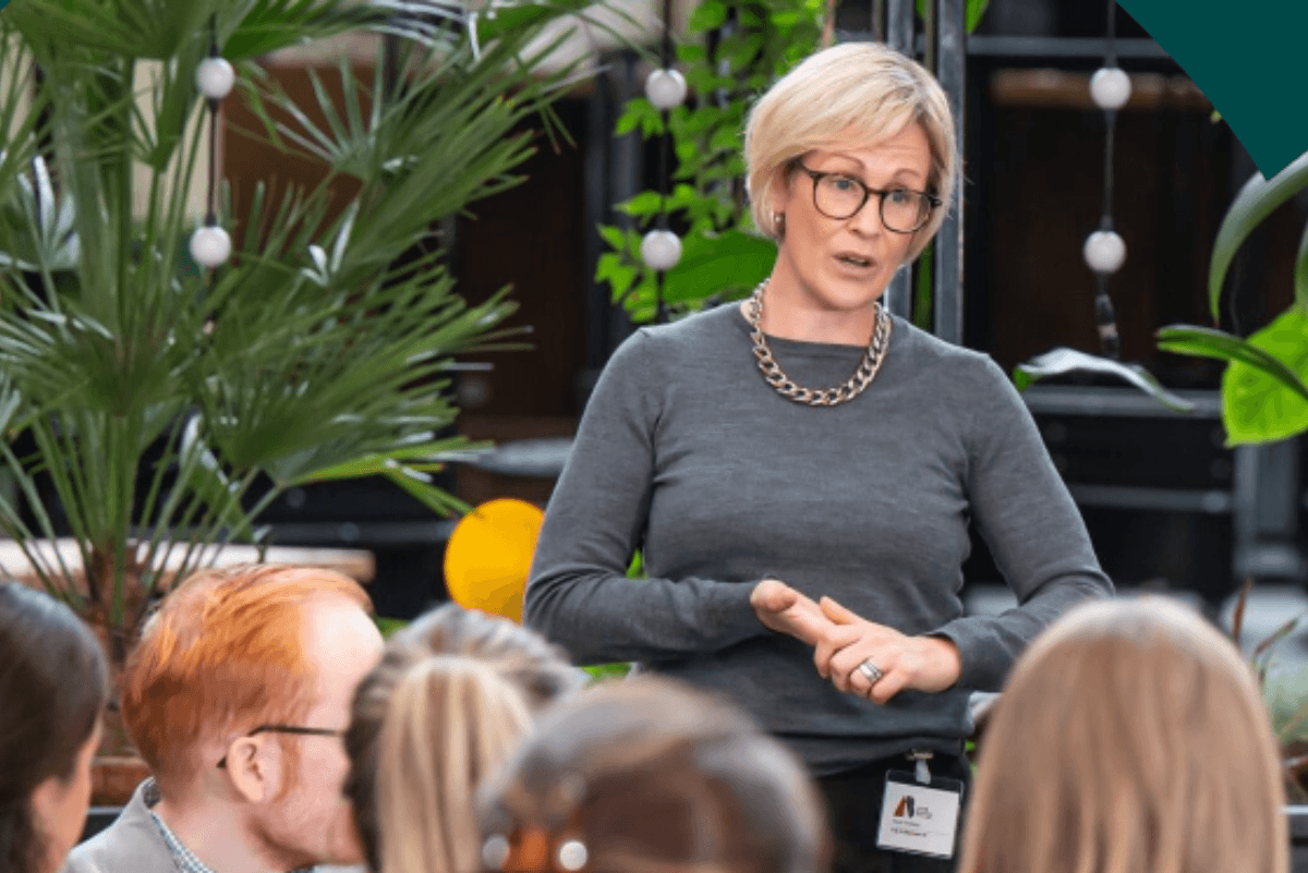 woman giving a presentation to a group of people&nbsp;