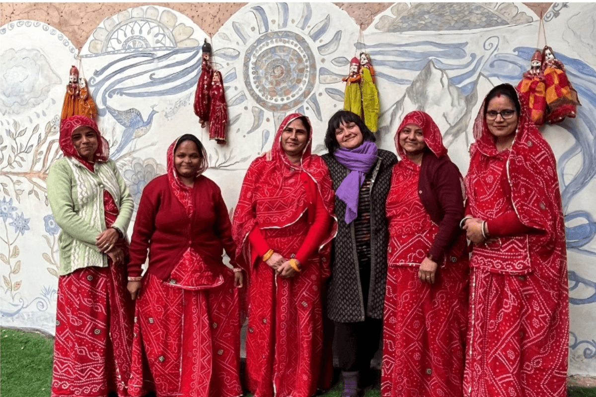 group of women in front of mural artwork&nbsp;