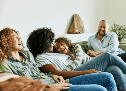 Family smile and spend time together on the sofa