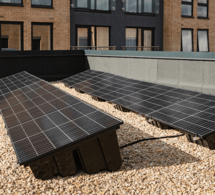 Image shows two plug in solar panels on the roof of a development