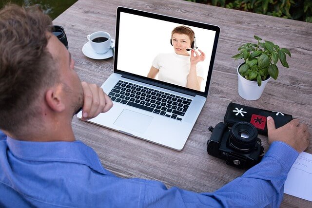 A person watching a webinar on a laptop 