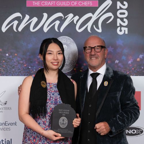 Photo of alumna Roselle W receiving award