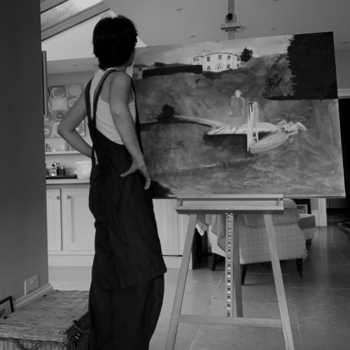 Photo of alumna Zoe Jones with one of her paintings