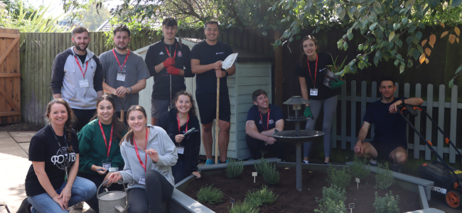 Photo of volunteers from Coreus with College staff in The HILL garden