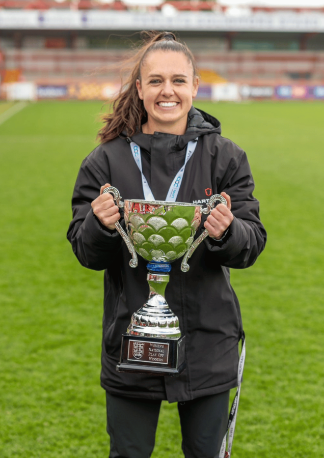 Photo of alumna Leah Burridge holding trophy