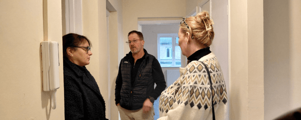 Two customers and a staff member assessing a void property.