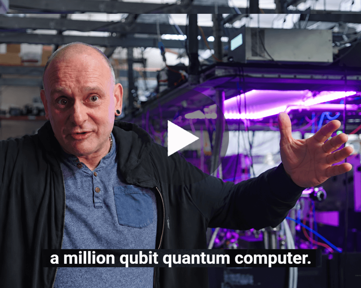 Professor Winfried Hensinger in the Sussex quantum lab, with purple-lit quantum computing equipment, a play button and the on-screen caption: “a million qubit quantum computer."