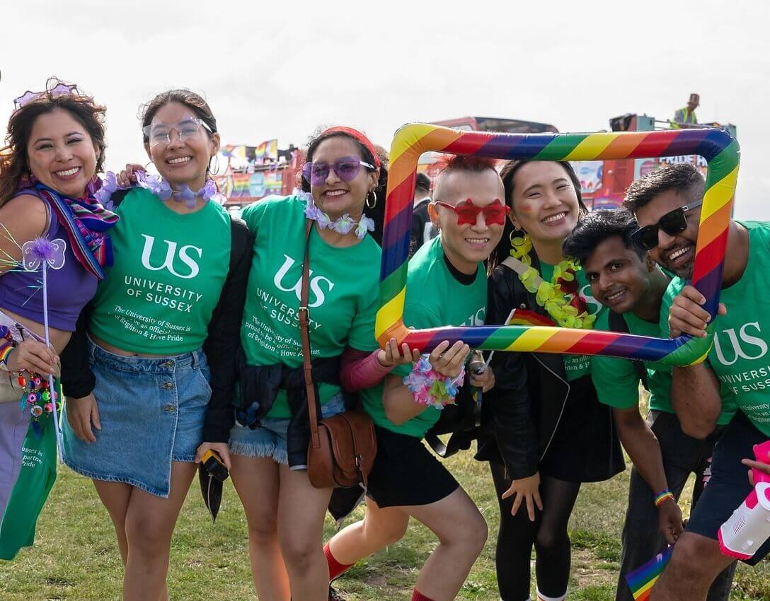 Student in Sussex branded t-shirts enjoying the Pride parade.